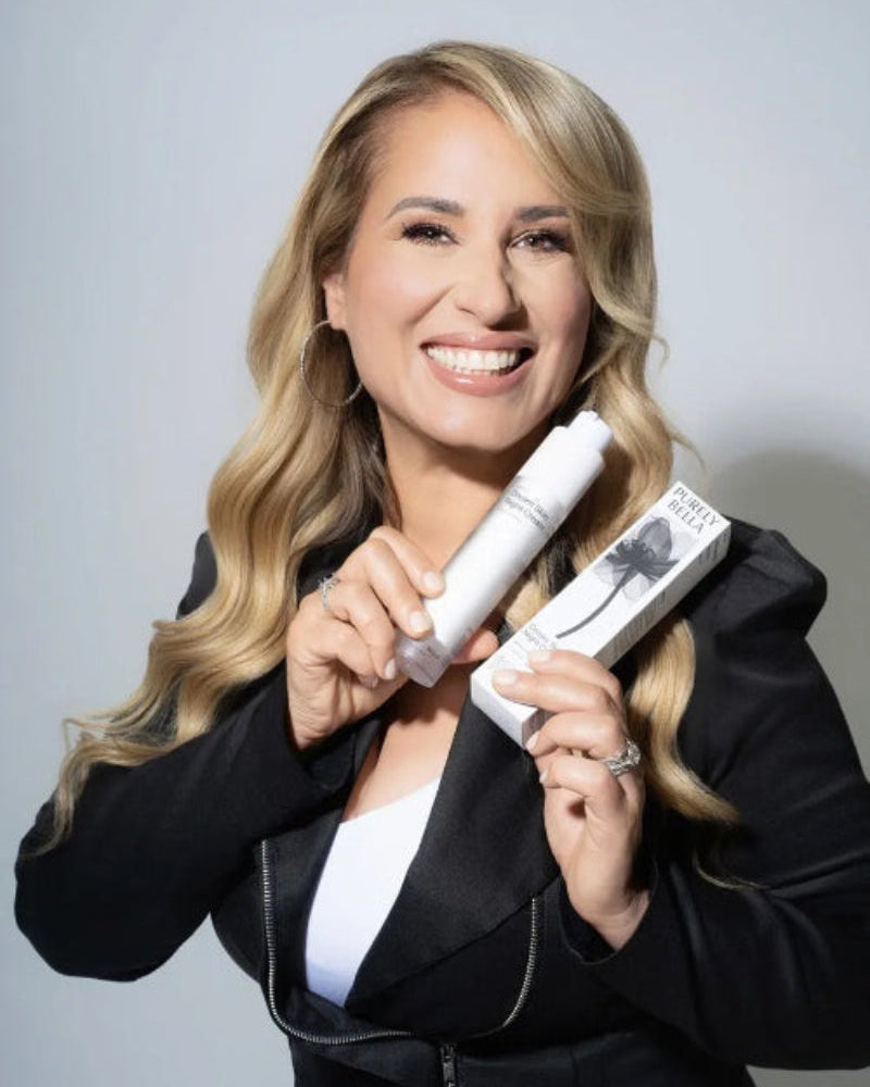 Woman holding a white hair product against a gray background