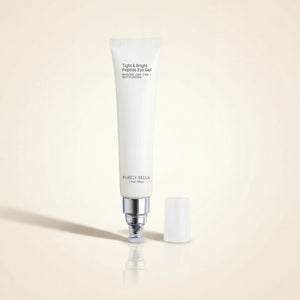 White eye gel tube with silver pump on a beige background