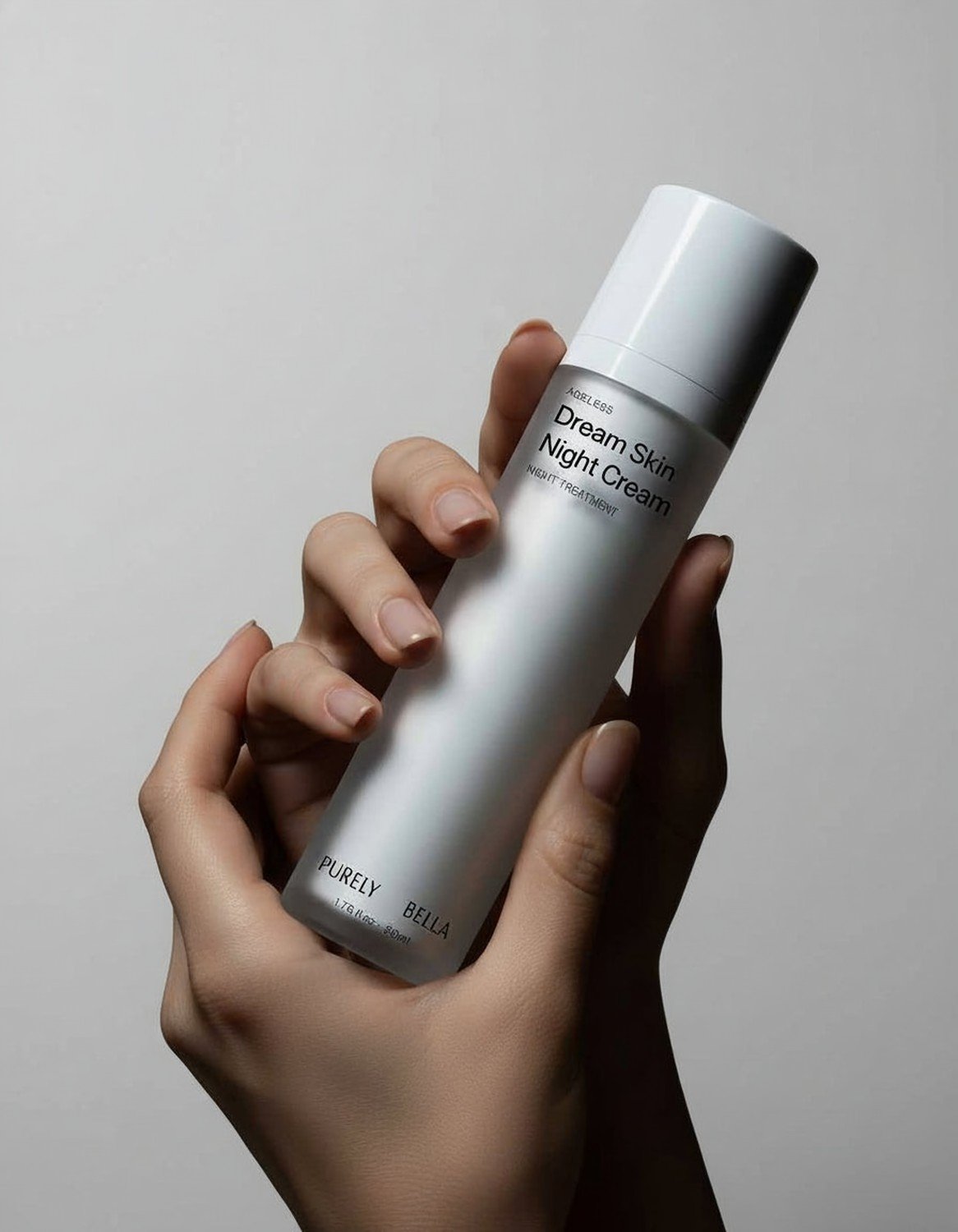 Dream Skin night cream bottle on marble with warm lighting