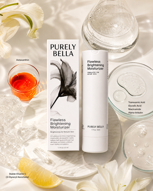 PURELY BELLA skincare products with flowers and a glass of orange juice on a light background