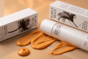 Purely Bella skincare cream with packaging on a beige background