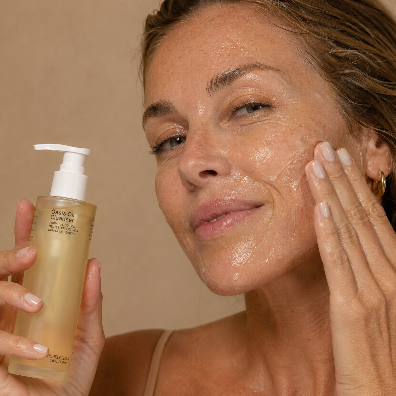Woman applying skincare product to her face with a beige background