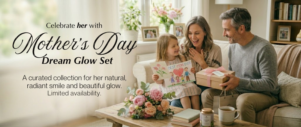 Family celebrating Mother's Day with a gift and flowers in a cozy living room.