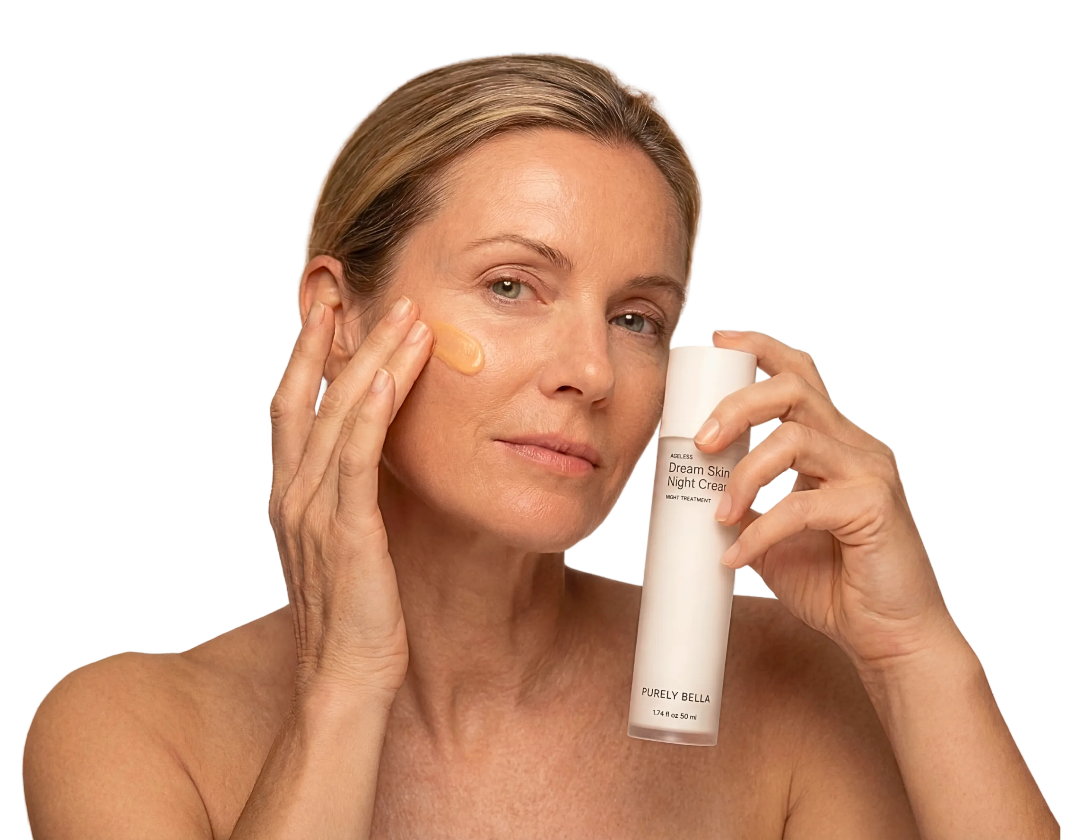 Woman applying skincare product to her face with a bottle of Purely Bella product.