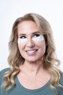 Woman wearing silicone eye masks - cooling reusable eye treatment for mature skin