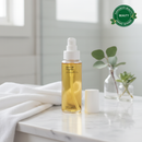 Bottle of Oasis Oil Cleanser on a marble surface with a plant and towel in the background, featuring Evergreen Beauty award badge. Best botanical Oil Cleanser