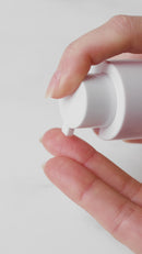 Dream Skin Night Cream Astaxanthin powered pumping on a woman's hand.